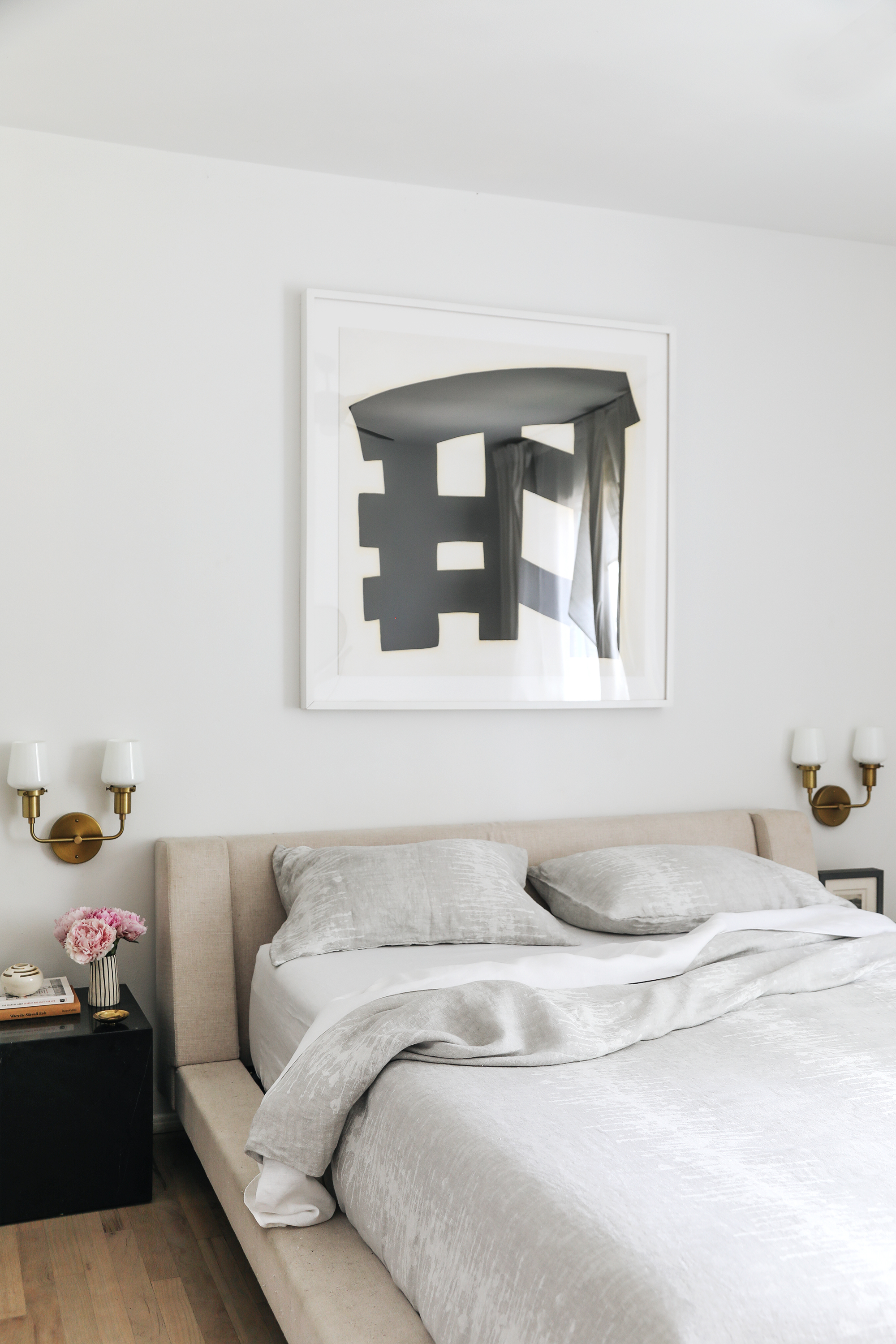 modern bedroom with upholstered headboard and linen bedding