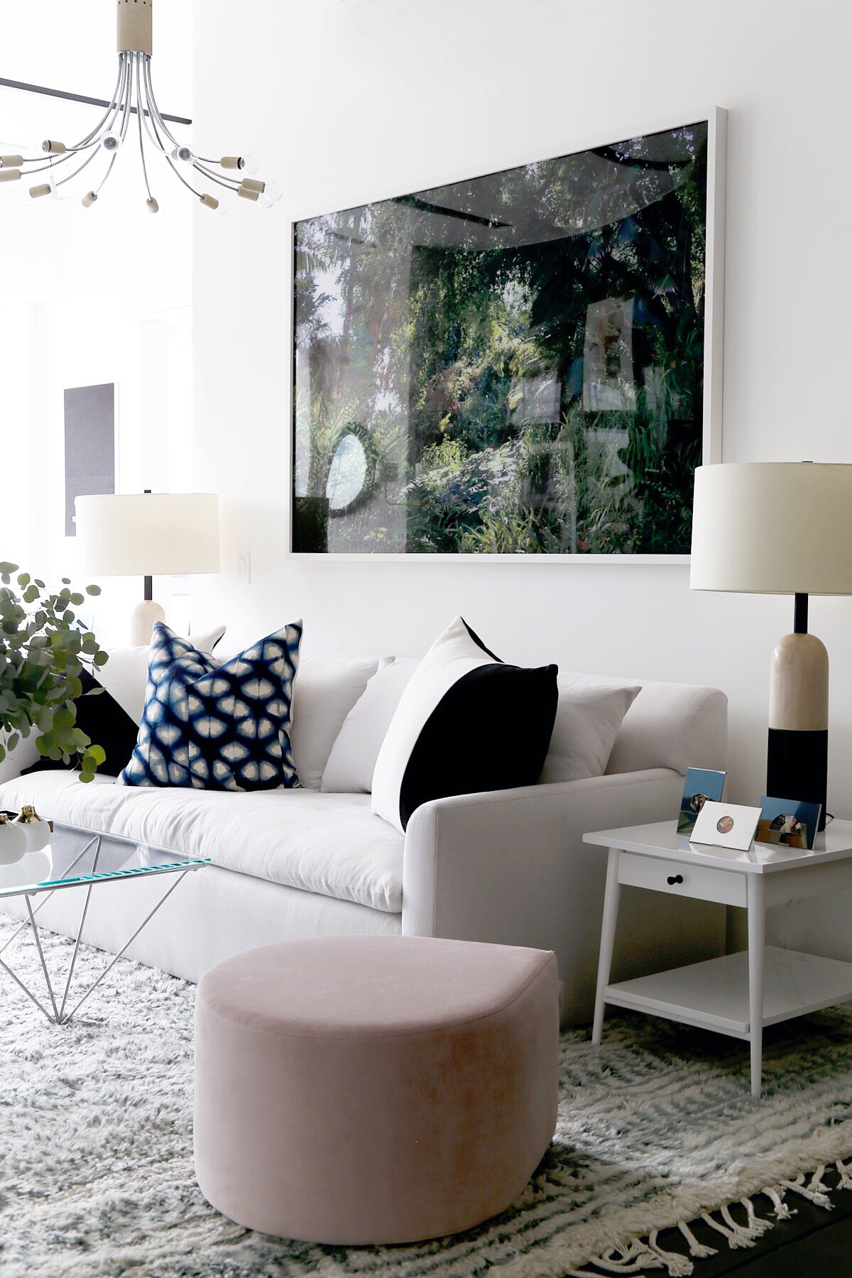 white living room with pops of color and oversized art via @citysage
