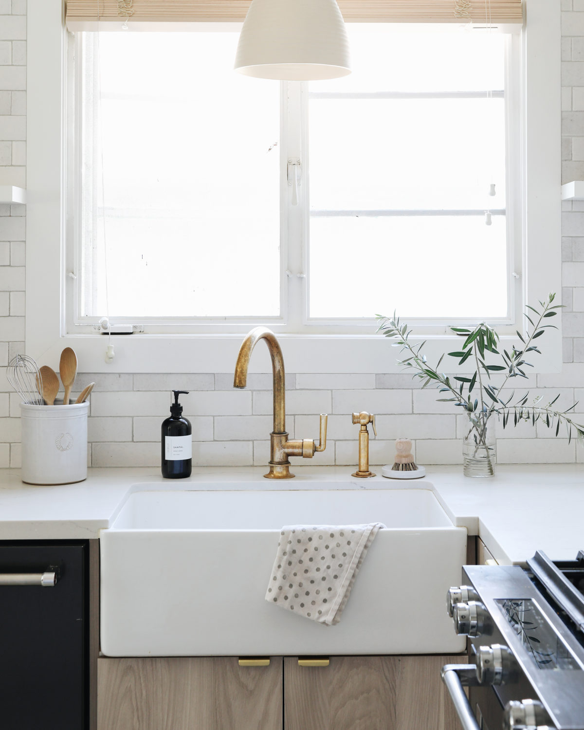 modern farmhouse kitchen with brass faucet