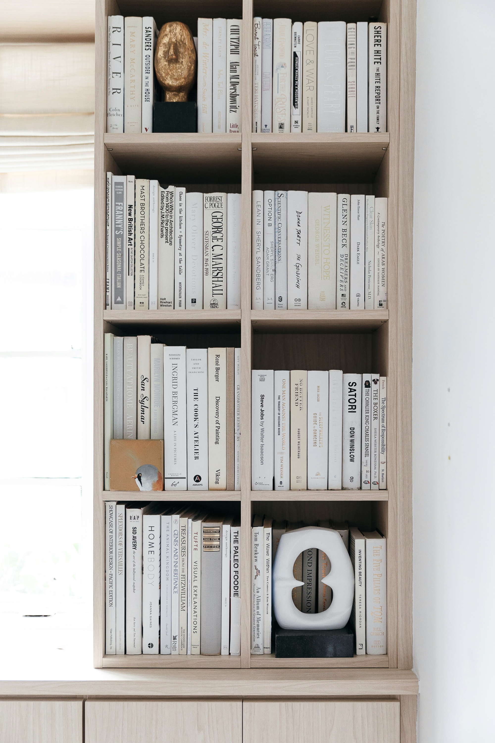 all white books on built-in bookshelves