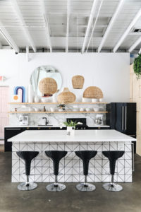 different shapes of rattan pendants over a kitchen island