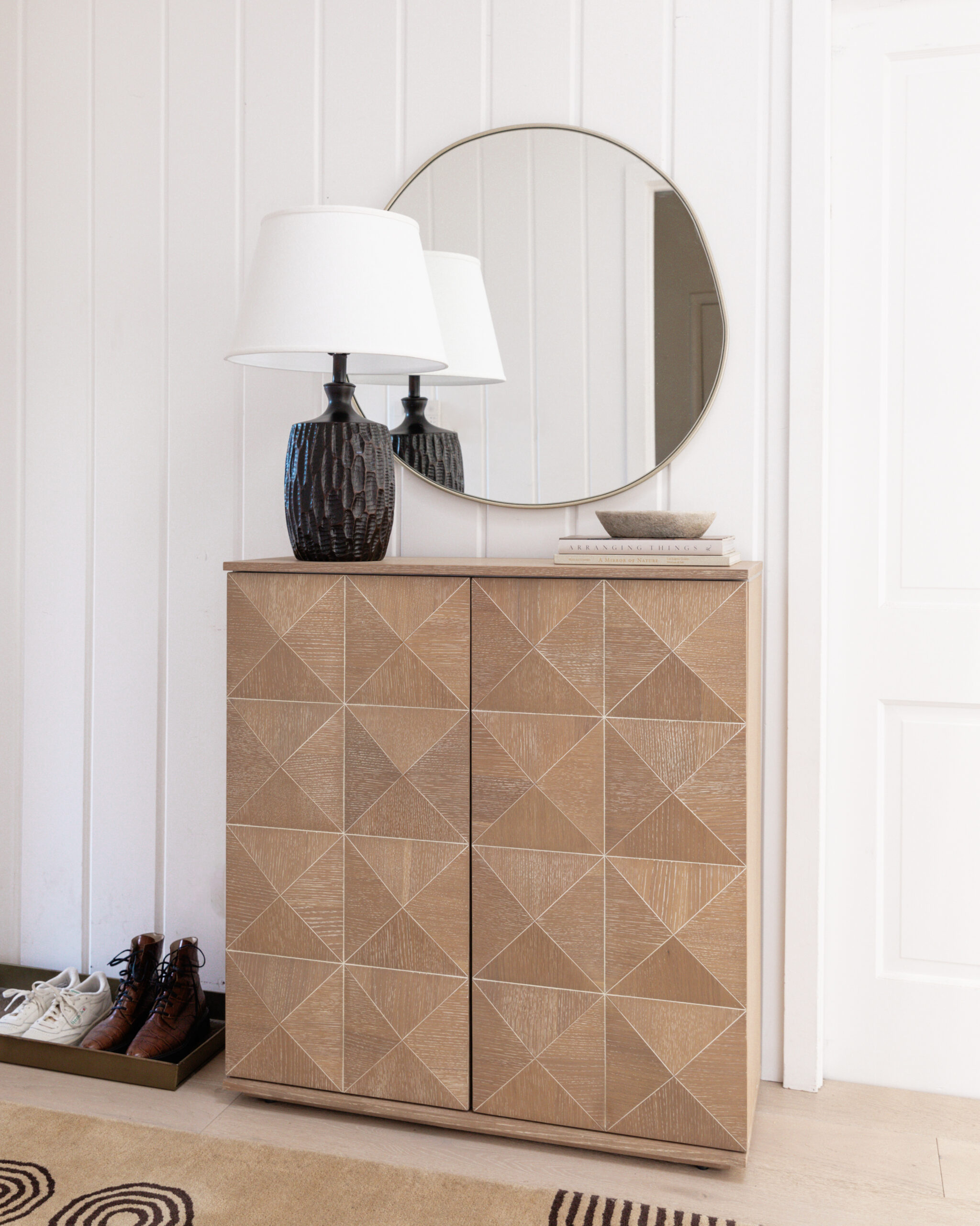modern neutral entryway with bronze lamp